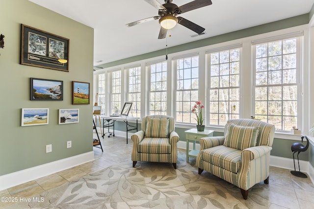 sitting room with ceiling fan and light tile patterned flooring