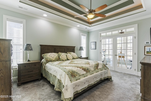 carpeted bedroom with ceiling fan, access to exterior, crown molding, and a raised ceiling