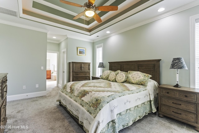 bedroom with ceiling fan, carpet flooring, crown molding, and a tray ceiling