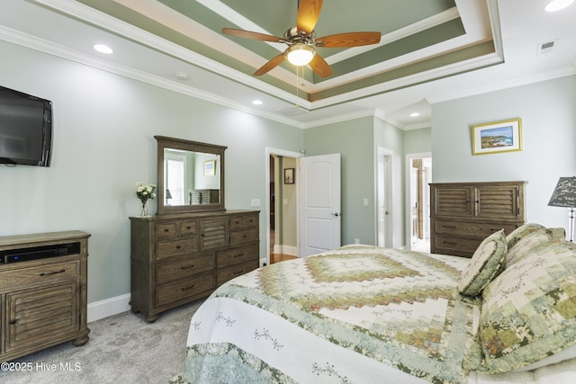 carpeted bedroom featuring ceiling fan, ornamental molding, and a tray ceiling