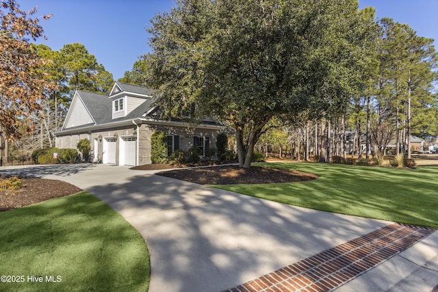 view of front of property featuring a front yard and a garage