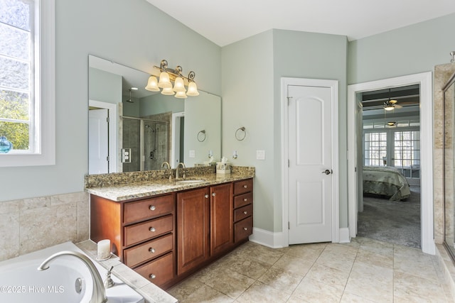 bathroom with ceiling fan, separate shower and tub, and vanity