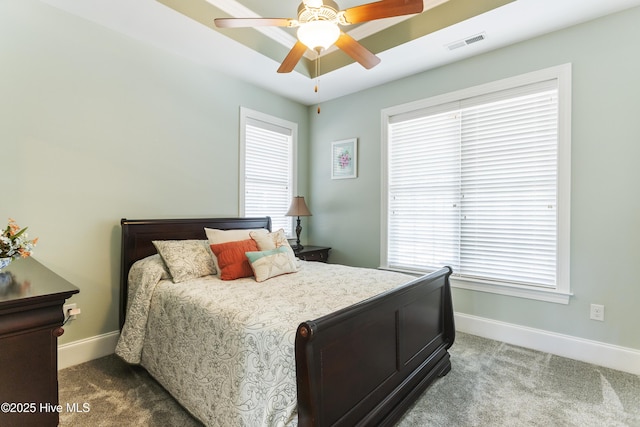 carpeted bedroom with ceiling fan and multiple windows