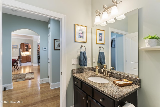 bathroom with vanity, crown molding, and hardwood / wood-style floors