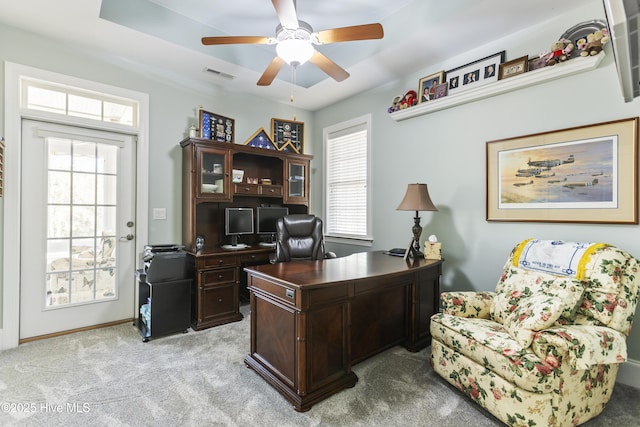 carpeted home office with ceiling fan