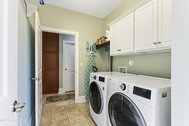 laundry area featuring cabinets and washing machine and clothes dryer