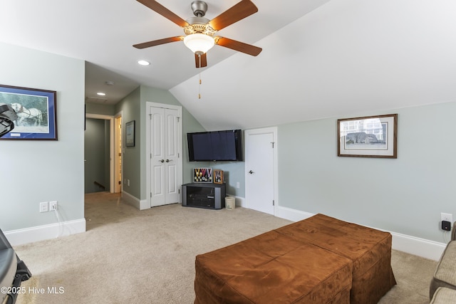 carpeted living room with vaulted ceiling and ceiling fan