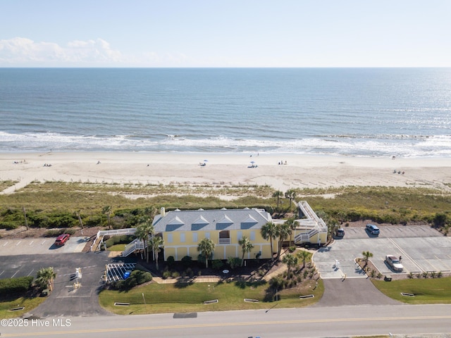 birds eye view of property featuring a view of the beach and a water view