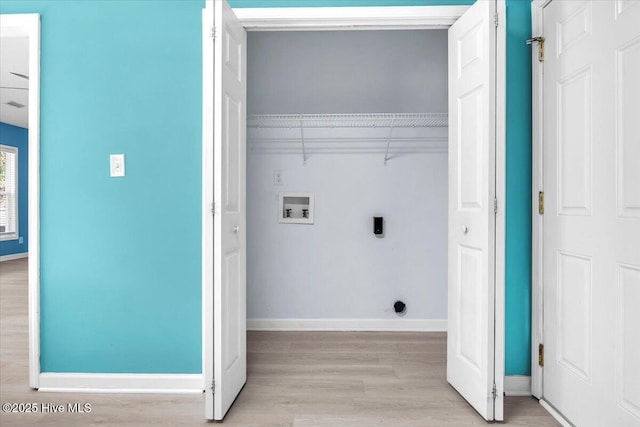 laundry area with light hardwood / wood-style floors, hookup for a washing machine, and electric dryer hookup