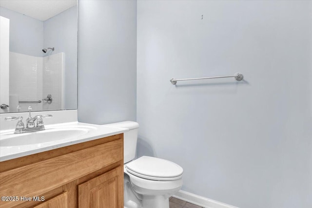 bathroom featuring vanity, tile patterned floors, a shower, and toilet