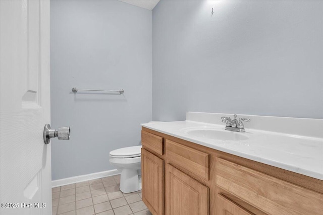 bathroom with tile patterned flooring, vanity, and toilet