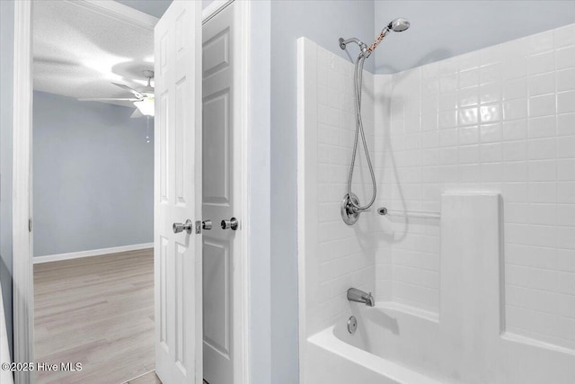 bathroom with wood-type flooring, a textured ceiling, and  shower combination