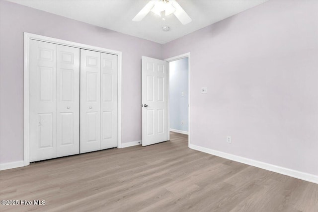 unfurnished bedroom featuring light hardwood / wood-style floors, ceiling fan, and a closet