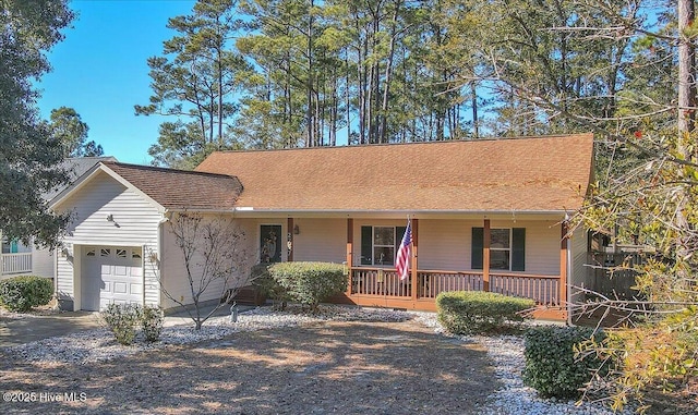 single story home with a porch and a garage