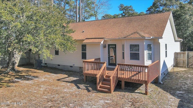 rear view of house with cooling unit and a deck