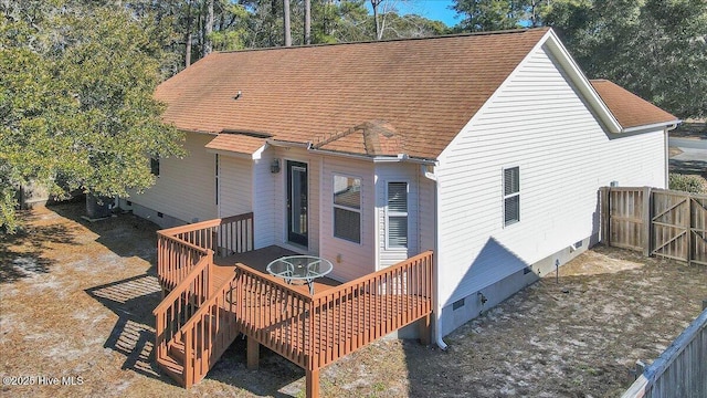 rear view of property featuring a wooden deck