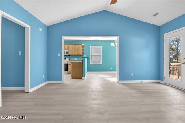 unfurnished living room with ceiling fan, vaulted ceiling, and light hardwood / wood-style flooring