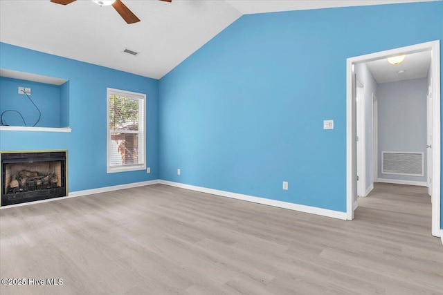 unfurnished living room featuring vaulted ceiling, ceiling fan, and light hardwood / wood-style flooring