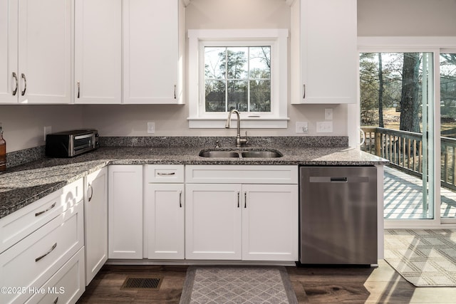 kitchen featuring white cabinetry and dishwasher