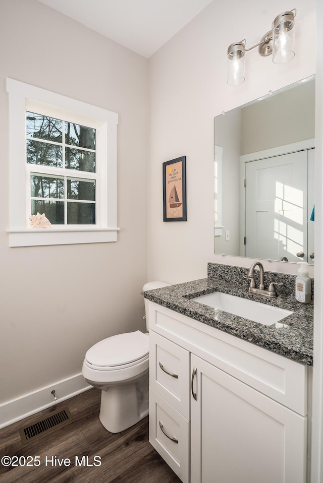 bathroom featuring hardwood / wood-style flooring, vanity, and toilet