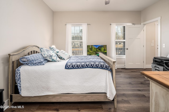 bedroom with ceiling fan and dark hardwood / wood-style flooring