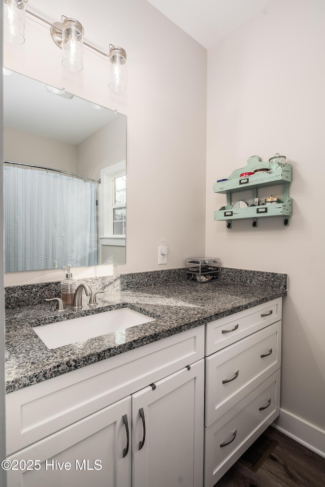 bathroom featuring vanity and hardwood / wood-style floors