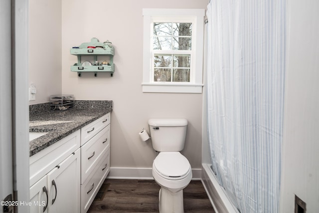 bathroom with vanity, toilet, curtained shower, and wood-type flooring