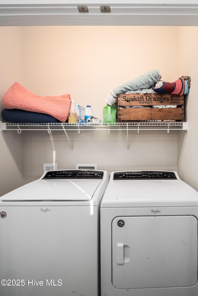 clothes washing area with washer and clothes dryer