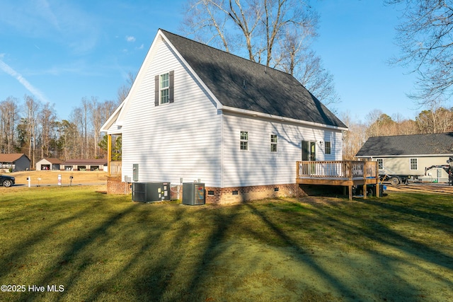 back of property featuring central AC, a deck, and a lawn