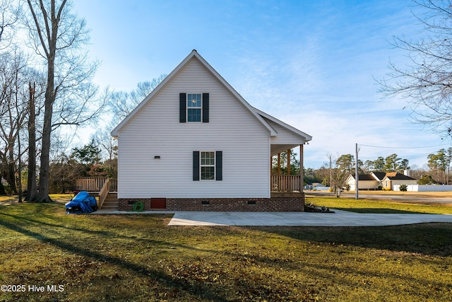 view of home's exterior with a porch and a yard