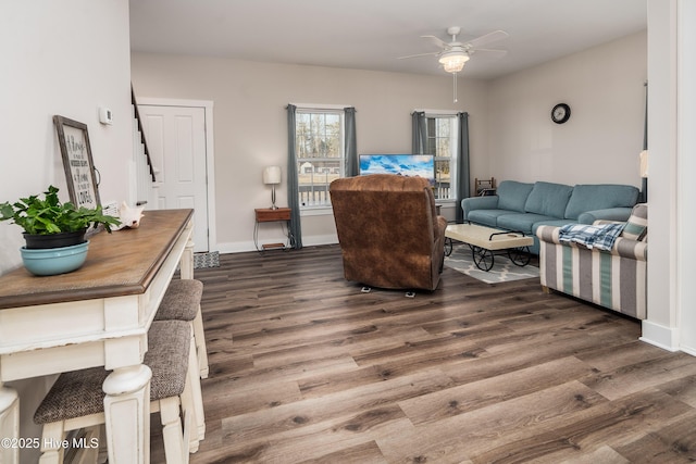 living room with dark wood-type flooring and ceiling fan