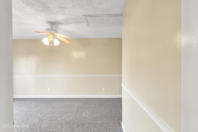 carpeted empty room with ceiling fan and a textured ceiling