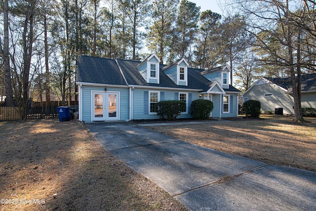 cape cod home featuring french doors