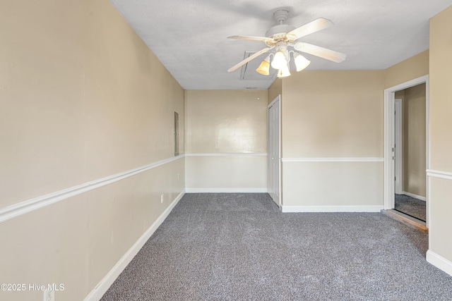 carpeted spare room featuring ceiling fan