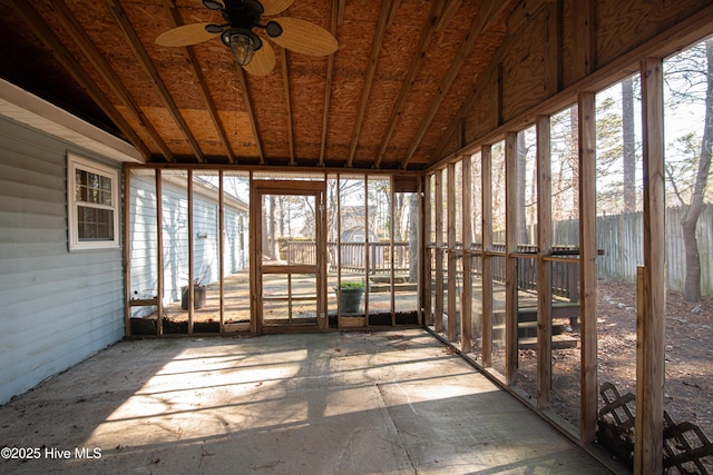 unfurnished sunroom featuring ceiling fan