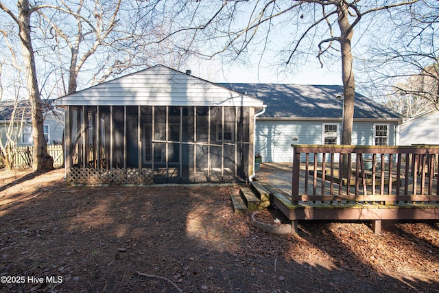 rear view of property with a deck and a sunroom