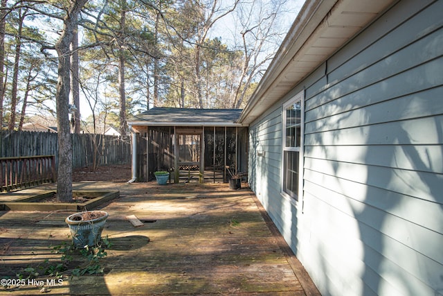 view of yard featuring a deck and a sunroom