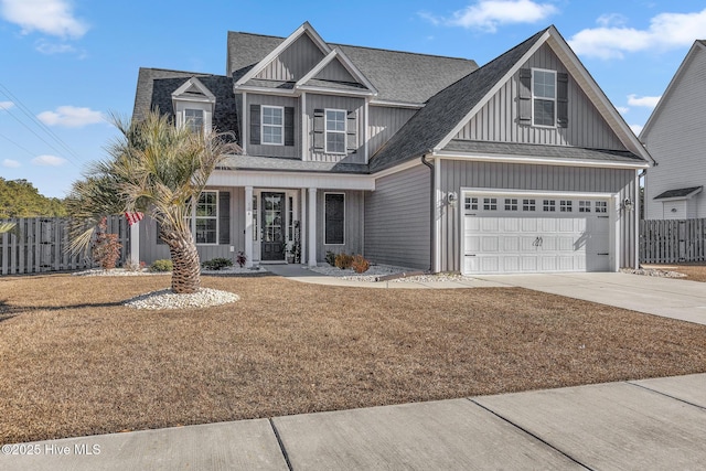 view of front of home with a front yard and a garage