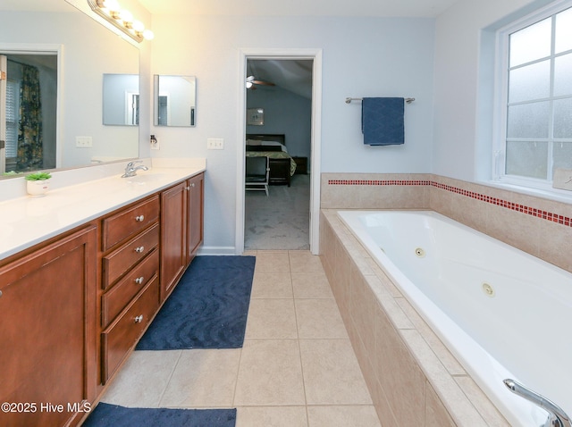 bathroom with a relaxing tiled tub, tile patterned floors, and vanity