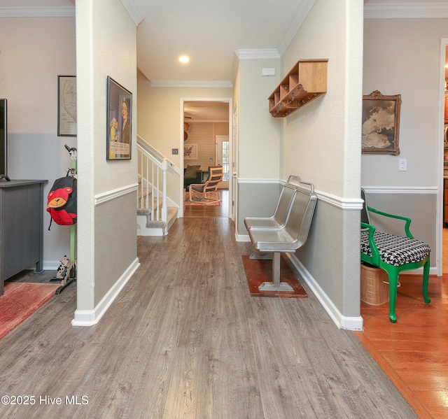 hall with hardwood / wood-style floors and ornamental molding