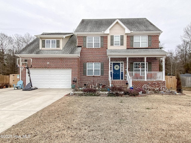 view of front of property with covered porch, a front yard, and a garage