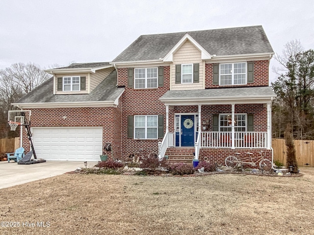 view of front of house featuring a garage, covered porch, and a front yard