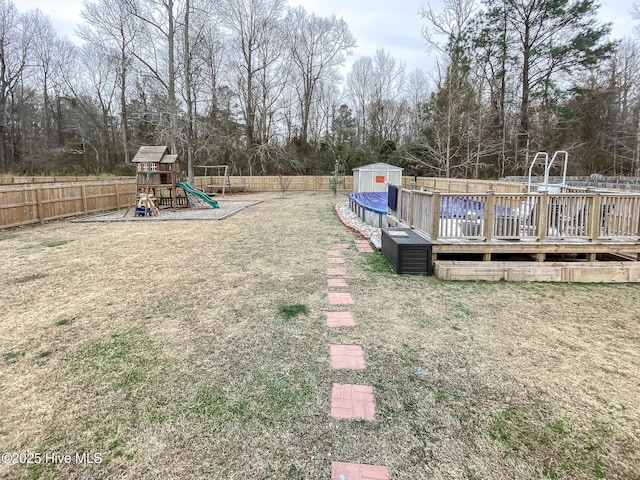 view of yard featuring a covered pool and a playground