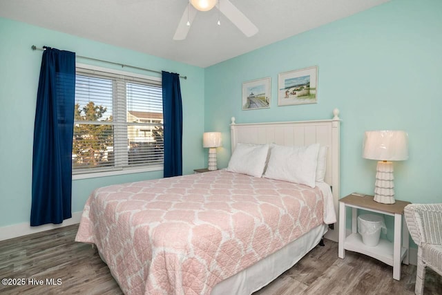 bedroom with wood-type flooring and ceiling fan