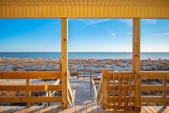 deck featuring a water view and a view of the beach