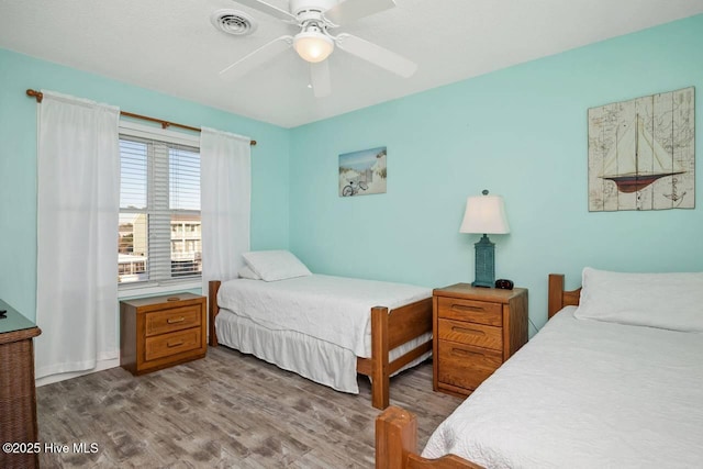 bedroom featuring hardwood / wood-style floors and ceiling fan