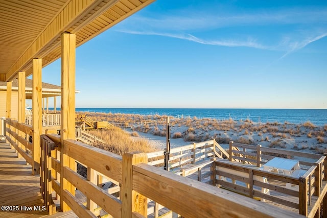 exterior space featuring a beach view and a water view