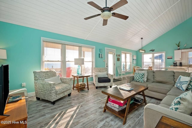 living room featuring vaulted ceiling, plenty of natural light, hardwood / wood-style floors, and wood ceiling