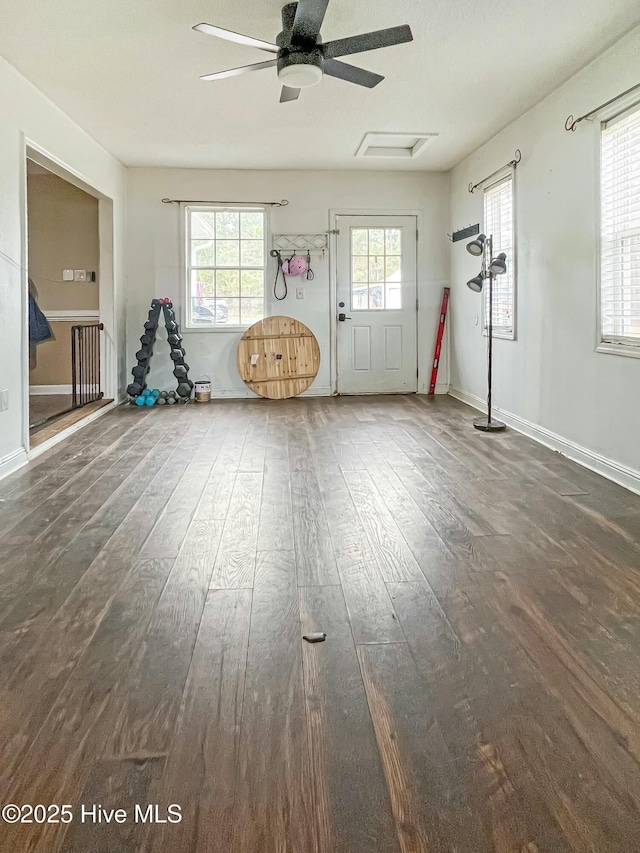 interior space with ceiling fan and dark hardwood / wood-style floors