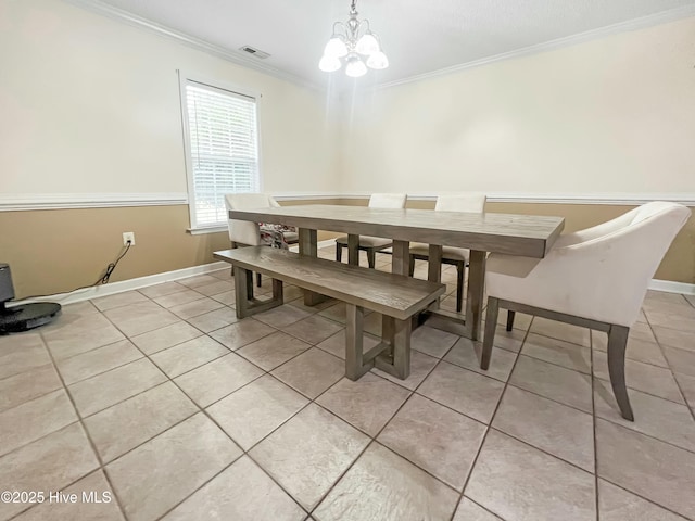 dining room with light tile patterned floors, crown molding, and a notable chandelier